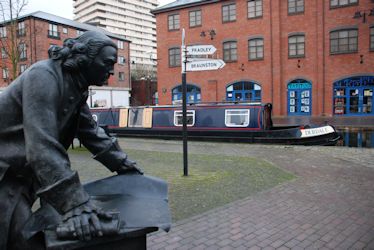 Debdale moored in Coventry Basin by the statue of James Brindley.